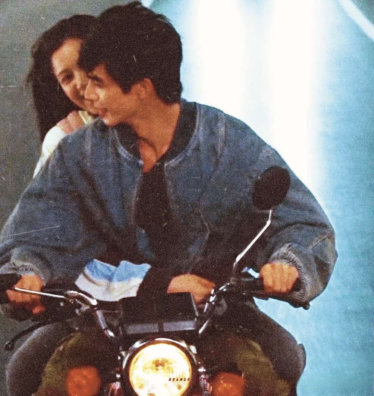 Two on a motorbike, monsoon light